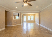 Thumbnail 11 of 18 - an empty living room with a ceiling fan