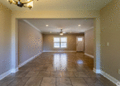 Thumbnail 5 of 18 - an empty living room with a chandelier
