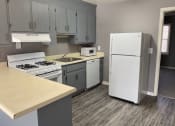 Thumbnail 6 of 13 - a kitchen with a stove a refrigerator and a sink