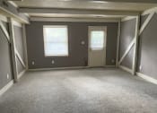Thumbnail 7 of 13 - an empty room with a door and two windows
