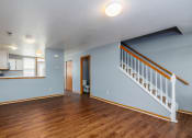 Thumbnail 20 of 23 - the living room and dining room of a house with blue walls and wood flooring