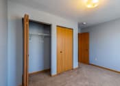 Thumbnail 16 of 23 - a empty room with a closet and a door to a bathroom