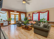 Thumbnail 10 of 23 - a living room with couches and chairs and a wood floor
