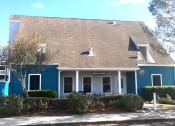 Thumbnail 12 of 15 - a blue building with bushes in front of it