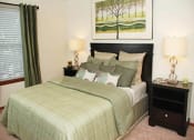 Thumbnail 13 of 15 - a bedroom with a bed and two nightstands