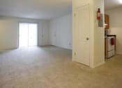 Thumbnail 3 of 15 - an empty living room with a kitchen in the background