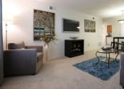 Thumbnail 4 of 15 - a living room with a couch and a tv