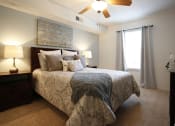 Thumbnail 6 of 15 - a bedroom with a bed and a ceiling fan
