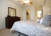 Thumbnail 7 of 15 - a bedroom with a bed and a ceiling fan