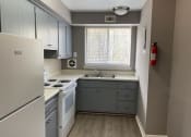 Thumbnail 13 of 13 - a kitchen with a stove a sink and a window