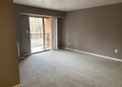 Thumbnail 9 of 13 - an empty living room with a sliding glass door