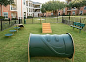 Thumbnail 6 of 29 - Dog park with agility equipment and obstacle course at Clearwater Creek Apartments, Richardson, TX 75082