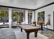 Thumbnail 22 of 25 - a game room with a pool table and windows