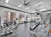 Thumbnail 11 of 25 - a gym with weights and other exercise equipment and windows