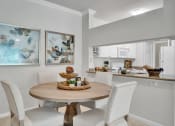 Thumbnail 20 of 25 - an open kitchen and dining room with a table and chairs