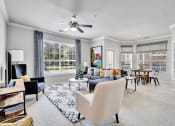 Thumbnail 8 of 25 - a living room with furniture and a ceiling fan