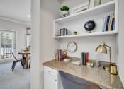 Thumbnail 19 of 25 - a home office with a desk and a clock on a shelf