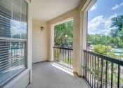 Thumbnail 17 of 25 - the view from the balcony of a home with a door open to a patio