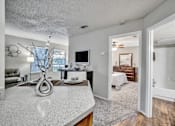 Thumbnail 10 of 32 - an open living room and kitchen with a view of a bedroom and a bathroom