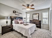 Thumbnail 28 of 32 - a bedroom with a bed and a ceiling fan