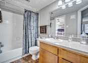 Thumbnail 24 of 32 - a bathroom with a shower toilet and sink and a mirror