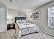 Thumbnail 26 of 32 - the master bedroom has a king sized bed and a window