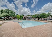 Thumbnail 16 of 32 - the preserve at ballantyne commons community swimming pool with trees and buildings