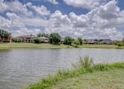 Thumbnail 15 of 32 - a body of water with houses in the background