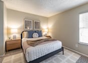 Thumbnail 31 of 31 - Bedroom with neutral decor and large window at Highland Park Apartments, Fort Worth, TX