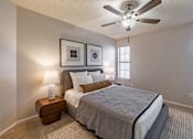 Thumbnail 5 of 31 - Bedroom with ceiling fan and wall art at Highland Park Apartments, Texas, 76132
