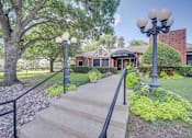 Thumbnail 22 of 32 - the front of a house with stairs and a sidewalk and lamp posts