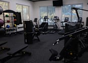 Thumbnail 13 of 29 - Fitness center with cardio and strength equipment at Clearwater Creek Apartments, Richardson, 75082