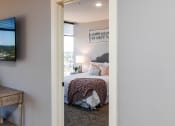 Thumbnail 17 of 106 - a bedroom with a bed and a tv in a 555 waverly unit