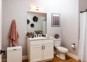 Thumbnail 28 of 106 - a bathroom with a white sink and toilet next to a white shower curtain and a pink towel