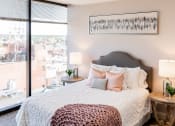 Thumbnail 18 of 106 - a bedroom with a large bed and a large window