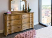 Thumbnail 21 of 106 - a bedroom with a dresser and mirror