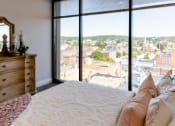 Thumbnail 22 of 106 - a bedroom with a bed and a large window