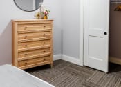 Thumbnail 27 of 106 - a bedroom with a dresser and mirror