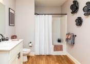 Thumbnail 29 of 106 - a bathroom with a white sink and toilet and a white shower curtain