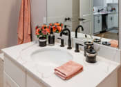 Thumbnail 30 of 106 - a bathroom with a sink and a mirror