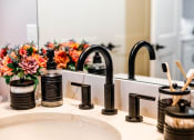 Thumbnail 31 of 106 - a bathroom sink with a black faucet