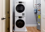 Thumbnail 33 of 106 - a washer and dryer in a small laundry room