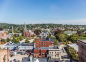 Thumbnail 36 of 106 - arial view of a small town with a church in the background