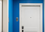 Thumbnail 34 of 106 - a white door with a black handle in a blue room