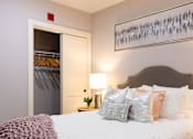 Thumbnail 91 of 106 - A bedroom with a bed, pillows, and a painting on the wall.