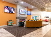 Thumbnail 41 of 106 - a lobby with a couch and a fireplace and a tv