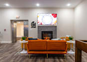 Thumbnail 61 of 106 - a living room with a couch and a fireplace