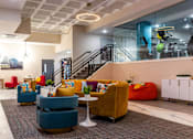 Thumbnail 45 of 106 - a lobby with couches and chairs and a staircase