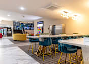Thumbnail 50 of 106 - a long communal table with blue chairs in a lobby