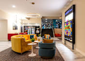 Thumbnail 39 of 106 - the lobby of a hotel with couches and chairs and a vending machine